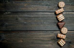 Chocolate sweets with nuts and various fillings. photo