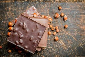 Hazelnut chocolate on wooden background. photo