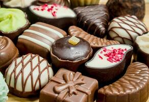 Chocolate candies with nuts and various fillings. photo