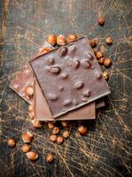 Hazelnut chocolate on wooden background. photo