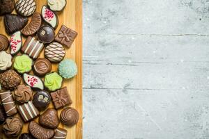 Various chocolate sweets on the Board. photo