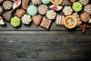 Chocolate sweets with nuts and various fillings. photo