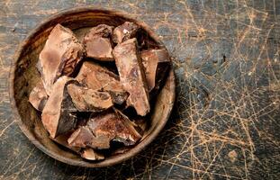 Crushed chocolate in the bowl . photo