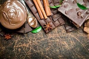 Chocolate paste with cinnamon and chocolate slices. photo