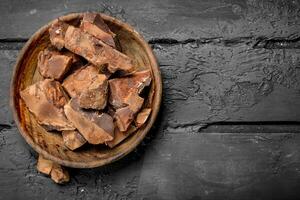 Crushed dark chocolate in a bowl . photo