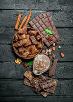 Chocolate background. Various assortment of chocolate with paste. photo