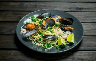 Mediterranean pasta. Seafood spaghetti with clams and lime. photo