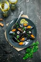 Mediterranean food. Spaghetti with cuttlefish ink, clams and white wine. photo