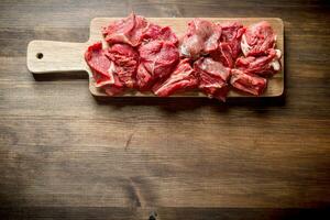 Sliced raw beef on a cutting Board. photo