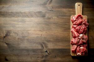 Sliced raw beef on a cutting Board. photo
