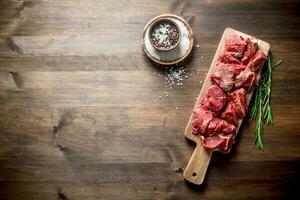 Cut raw beef with rosemary and seasonings. photo