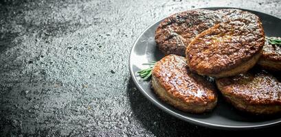 Cutlets on a plate with rosemary. photo