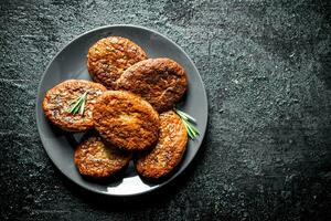 Cutlets on a plate with rosemary. photo