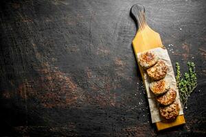 Cutlets on paper with thyme. photo