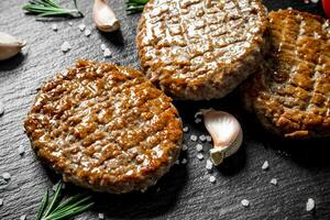 Cutlets with pieces of salt,rosemary and garlic. photo