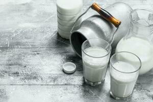 Fresh milk in glasses with a can. photo