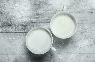 The milk in the mugs. photo