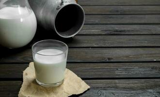 Fresh milk in a glass with a can. photo