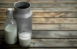 Fresh milk in a glass with a can. photo