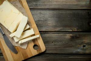 Butter with a knife on the Board. photo