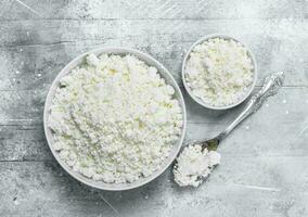 Cottage cheese in a bowl with a spoon. photo