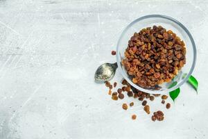 Raisins in a glass bowl. photo