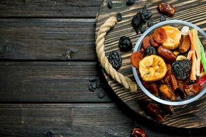 Assortment of different dried fruits in bowl. photo