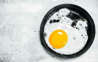 Fried egg in a frying pan. photo