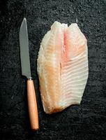 Fish fillets with a knife. photo