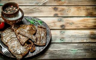 Grilled beef steaks with spices and rosemary. photo