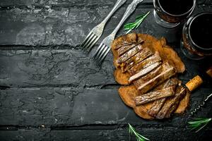 Sliced grilled steak with wine. photo