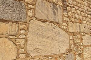 interesting vintage background with beige stones in a wall close-up photo