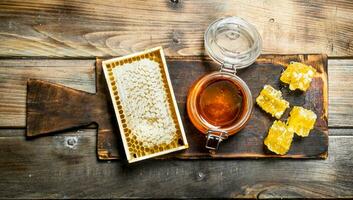 Bee honey on an old Board. photo