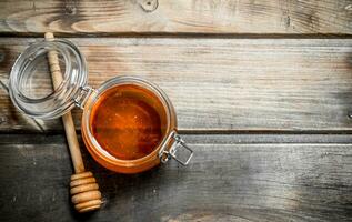 Fresh honey in a glass jar. photo