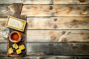 Bee honey on an old Board. photo