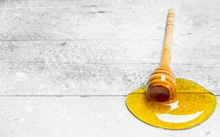 Natural honey with a wooden spoon. photo