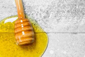 Natural honey with a wooden spoon. photo