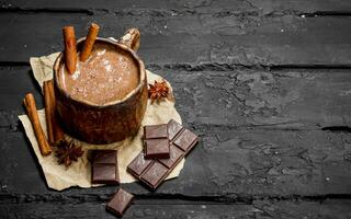 Hot chocolate with cinnamon sticks. photo