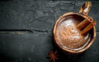 Hot chocolate with cinnamon sticks. photo