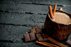Hot chocolate with cinnamon sticks. photo