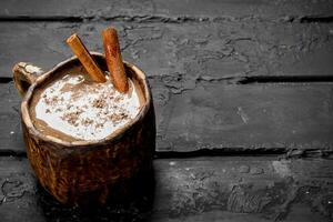 Hot chocolate with cinnamon sticks. photo