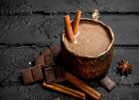 Hot chocolate with cinnamon sticks. photo