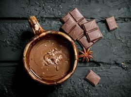 Hot chocolate with cinnamon sticks. photo