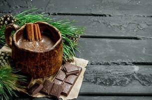 Hot chocolate with cinnamon sticks. photo