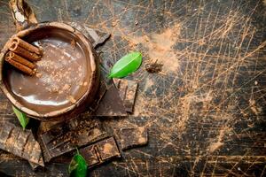 Cup of hot chocolate with cinnamon sticks. photo