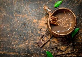 taza de caliente chocolate con canela palos foto