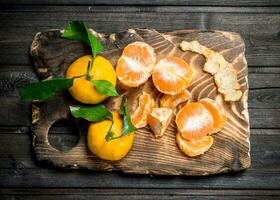 Slices of mandarins on the cutting Board. photo