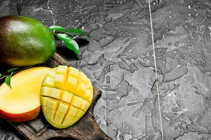 Pieces of fresh mango on the cutting Board. photo