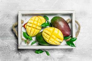 Fresh ripe mangoes in the tray. photo