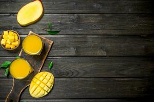 Mango juice in a glass on a cutting Board. photo